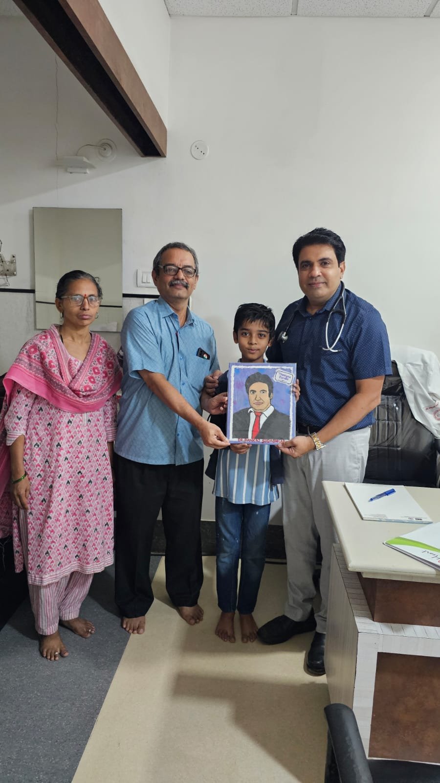 The Save Little Heart Foundation team with a child and family